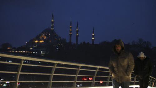 People walk over the Golden Horn Bridge in Istanbul, Friday, Jan. 6, 2017. Turkey's economy is suffering in the face of a string of extremist attacks -- including the nightclub massacre of New Year's revelers, most of them foreigners -- and uncertainty following the failed coup in July against President Recep Tayyip Erdogan that saw more than 270 people killed. AP Photo/ Emrah Gurel)