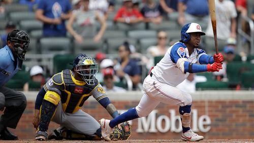 Braves' Ozzie Albies (right) grounds out in the seventh inning against the Milwaukee Brewers Sunday, Aug. 1, 2021, at Truist Park in Atlanta. (Ben Margot/AP)