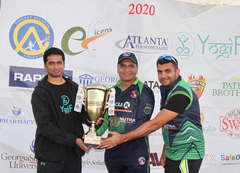 Shafiq Jadavji, center, a native of Africa, said he learned the sport of cricket as a youth while living in Asia and Pakistan. The financial advisor is captain of the Atlanta cricket club, Southeast Xpress. The team won the YogiFi Leatherball T-20 Championship in November. Jadavji is pictured with Vinod Ajjarapu, left, co-founder of YogiFi and teammate Parvez Dawoodani. Courtesy Shafiq Jadavji