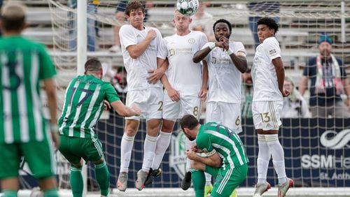 A wall comprised of Atlanta United 2's Aiden McFadden (2), Chris Allan (8), Bradley Kamdem Fewo (6) and Caleb Wiley (13) attempt to block a penalty kick by Oklahoma City Energy's Jonathan Brown (17) during a USL Championship match Sunday, May 16, 2021, at Taft Stadium in Oklahoma City, Okla.