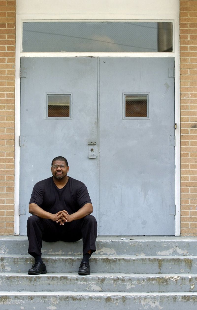 Michael Langford sits on the steps to the West Hunter Baptist Church gym in Atlanta, where he used to lead prayers before groups of volunteers would head out to patrol neighborhoods traumatized by the Atlanta Child Murders. 