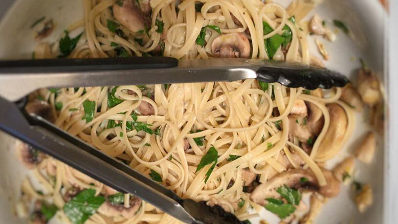 Soaking mushroom in olive oil, salt and lemon juice "cooks" them while the pasta boils. (Kathleen Purvis/Charlotte Observer/TNS)