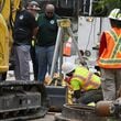 Workers work on to fix the water main break at Joseph E. Boone Boulevard and James P. Brawley Drive, Saturday, June 1, 2024, in Atlanta. A water main that ruptured, causing thousands to lose access to water around Atlanta, was repaired Saturday morning but water may take several hours to be restored.(Hyosub Shin / AJC)
