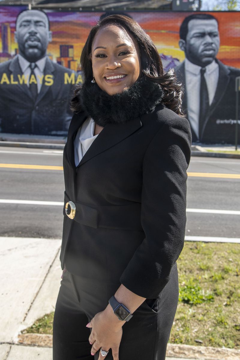 Coretta Whipple, who was named after Coretta Scott King, poses in front of a mural down the street from King's old Vine City in Atlanta. “I have never tried to dishonor her name in any way,” Whipple said. (Alyssa Pointer / Alyssa.Pointer@ajc.com)