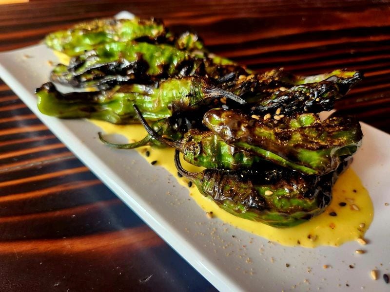 Grilled shishito peppers come with a mild carrot-ginger dressing at Yakitori Kona. Courtesy of Yakitori Kona