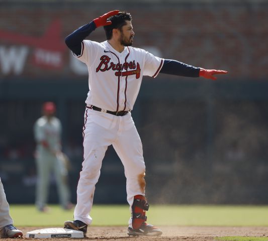 Atlanta Braves' Travis d'Arnaud doubles to score Matt Olson and William Contreras during the fifth inning of game one of the baseball playoff series between the Braves and the Phillies at Truist Park in Atlanta on Tuesday, October 11, 2022. (Jason Getz / Jason.Getz@ajc.com)