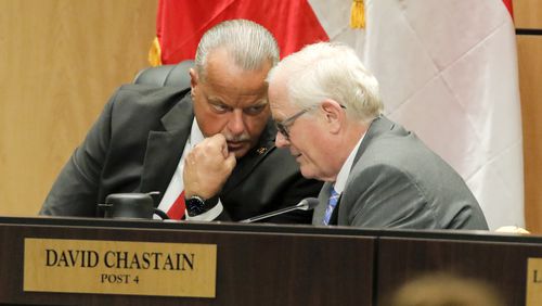 Superintendent of the Cobb County School District Chris Ragsdale and board member David Chastain speak during a Cobb County school board meeting in Marietta on July 15, 2021. Employees in the Cobb County School District will receive raises in the 2022-2023 budget. (Christine Tannous / AJC file photo)
