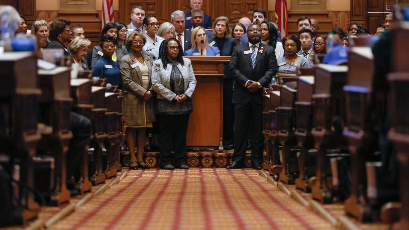 Surrounded by members of the House of Representatives, Rep. Esther Panitch addresses recent  antisemitic attacks earlier this month.  (Natrice Miller/natrice.miller@ajc.com)