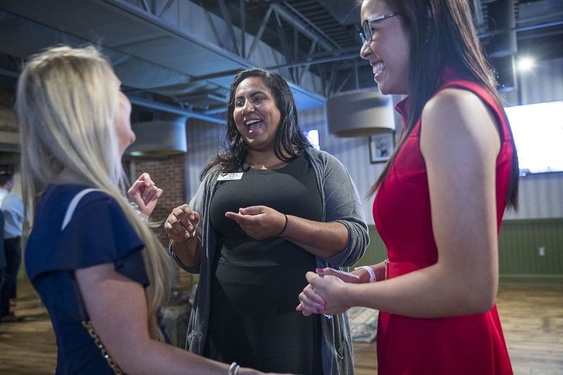 Sunita Theiss (center) shares a laugh with Ashely Quagliaroli (left) and Beatrice Shakal (right) following a panel discussion about issues affecting women in Atlanta suburbs during the Atlanta Young Republicans monthly meeting at City Tap in Atlanta, Wednesday, September 25, 2019. Sunita is the director of women's outreach for the Atlanta Young Republicans.   (Alyssa Pointer/alyssa.pointer@ajc.com)