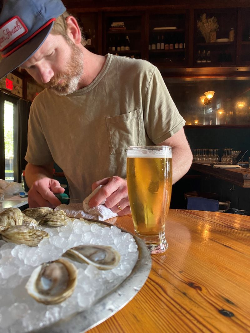 Bryan Rackley shucks Shiny Dimes oysters at Kimball House.
Bob Townsend for the Atlanta Journal Constitution