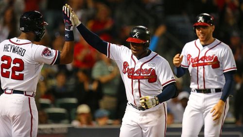 092414 Atlanta: Braves Justin Upton (center) celebrates his 2-run homer with Jason Heyward and Freddie Freeman to take a 6-0 lead over the Pirates during the fourth inning of a baseball game on Wednesday, Sept. 24, 2014, in Atlanta. CURTIS COMPTON / CCOMPTON@AJC.COM Justin Upton joins Jason Heyward as an ex-Brave. Freddie Freeman: still here. (Curtis Compton, ccompton@ajc.com)
