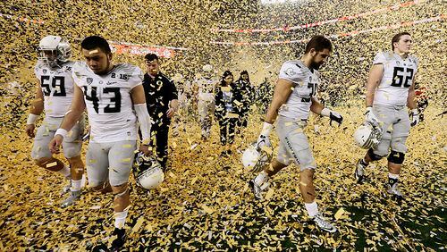 AP10ThingsToSee - Oregon players walk off the field after losing to Ohio State, 42-20, in the NCAA college football playoff championship game, Monday, Jan. 12, 2015, in Arlington, Texas. (AP Photo/Brandon Wade)