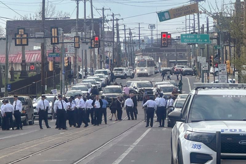 Police and officials gather on a cordoned off street at the scene of a shooting, Wednesday, April 10, 2024, in Philadelphia. (AP Photo/Claudia Lauer)