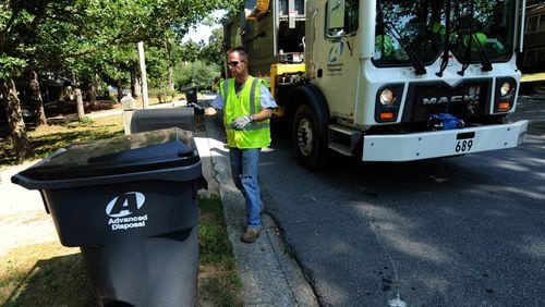 Advanced Disposal takes over residential waste hauling in Canton on Oct. 1. Residents are asked to leave their old green trash carts on the curb so they can be replaced with new, gray containers. AJC FILE
