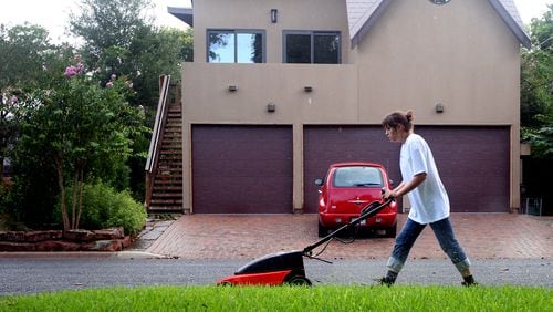 Ricardo B. Brazziell AMERICAN-STATESMAN 8/18/07 Katherine Weil mows a lawn with an environmental friendly mower in north Austin on Saturday Morning, August 18, 2007.