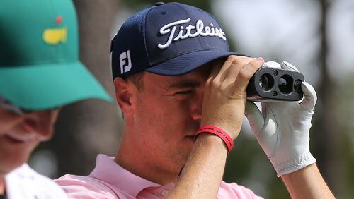 Justin Thomas checks the distance from the fourth tee box to the flag stick on the par-3 hole during his practice round for the Masters at Augusta National Golf Club on Monday, April 2, 2018, in Augusta.  Curtis Compton/ccompton@ajc.com