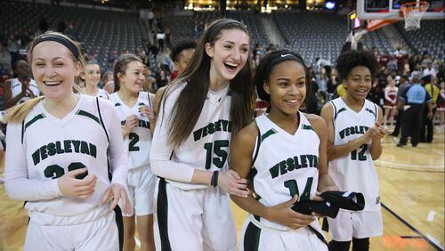 March 9, 2018 - Atlanta, Ga: Wesleyan's Callie Weaver (32), Sutton West (15), Amaya Register (14), and Paige Lyons (12) celebrate their win against Holy Innocents during the GHSA Class A Private Girls State Championship at McCamish Pavilion Friday, March 9, 2018, in Atlanta. Wesleyan won 61-44. PHOTO / JASON GETZ