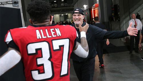 Falcons head coach Dan Quinn and safety Ricardo Allen celebrate a 24-20 victory over the Philadelphia Eagles.  Curtis Compton/ccompton@ajc.com