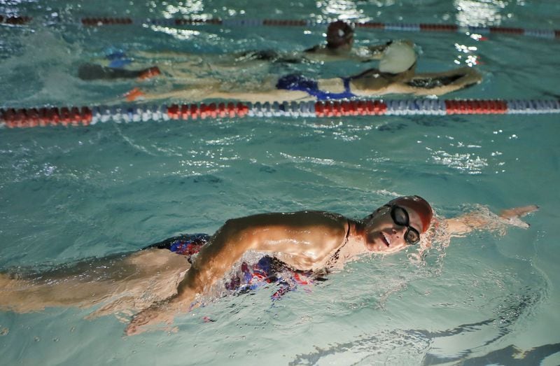 Vicki Bunke trains at about 5 a.m at a pool in Marietta to prepare for the Swim Across America event. She was keeping a promise to her daughter Grace, who died in March. BOB ANDRES / BANDRES@AJC.COM