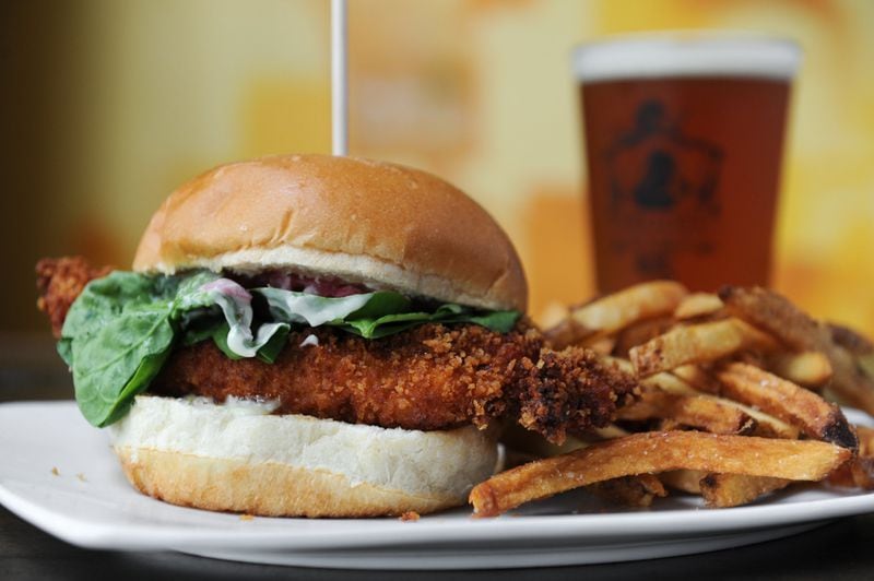 The Crispy Fried Chicken Sammich served at Argosy is made with soy lime marinated chicken breast, baby spinach, pickled onions, sesame mayo and an H&F bun. (BECKY STEIN)