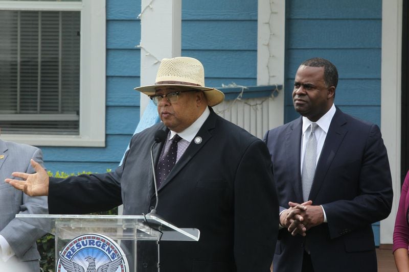 City Council Member Ivory Young, with Mayor Kasim Reed behind him, is one of seven city council members who have received political donations from a committee created in 2016 to help secure passage of a transportation sales tax. HENRY TAYLOR / AJC