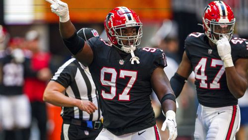 Falcons defensive end Grady Jarrett (97) signals during the first half of an NFL football game against the San Francisco 49ers, Sunday, Oct. 16, 2022, in Atlanta. (AP Photo/Danny Karnik)