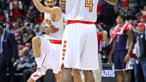 April 24, 2017, Atlanta: Atlanta Hawks Jose Calderon (from left), Kent Bazemore, and Paul Millsap celebrate scoring against the Washington Wizards with Bradley Beal watching on the way to a 111-101 victory in game 4 of a first-round NBA basketball playoff series on Monday, April 24, 2017, in Atlanta. Curtis Compton/ccompton@ajc.com