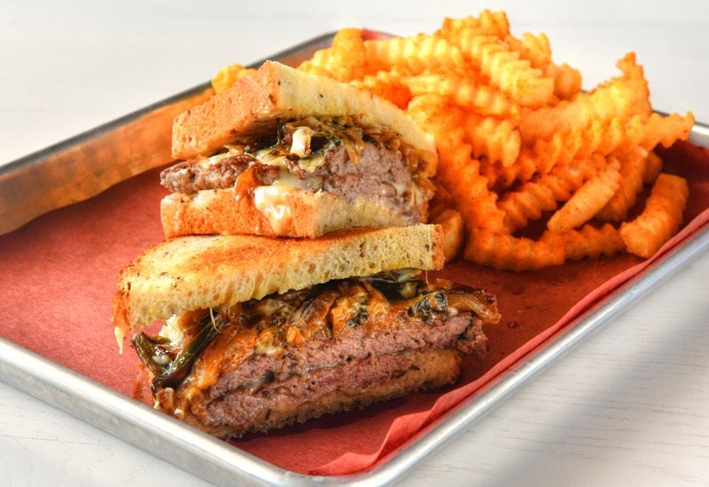 The Fox Bros.' Foxy Melt has brisket patties, American cheese, onions, poblanos and beef fat dijonnaise on rye bread. (Chris Hunt for The Atlanta Journal-Constitution)