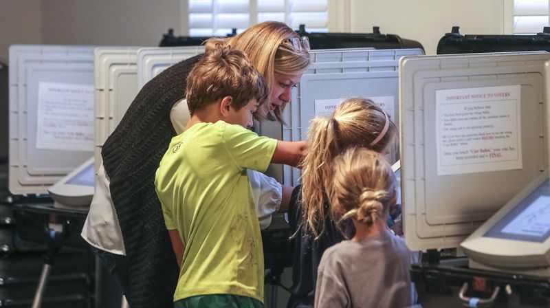 November 5, 2019  DeKalb County: Sarah Jones votes with her children, Left to Right - Noah-9,Elise-6 and Anna-6 at The Gathering at the Church at Decatur Heights polling place at 735 Sycamore Drive in Decatur on Tuesday, Nov. 5, 2019. The county of DeKalb voted on a referendum that would restructure the county's ethics board after the Georgia Supreme Court ruled that the way its members are currently appointed is unconstitutional. Critics of the proposal say the restructuring would weaken the ethics board and reduce some of its powers. Every city in DeKalb also had municipal elections for mayor or city council this fall with several incumbent mayors are facing challengers. There were scores of mayoral and city council seats up for grab  JOHN SPINK/JSPINK@AJC.COM