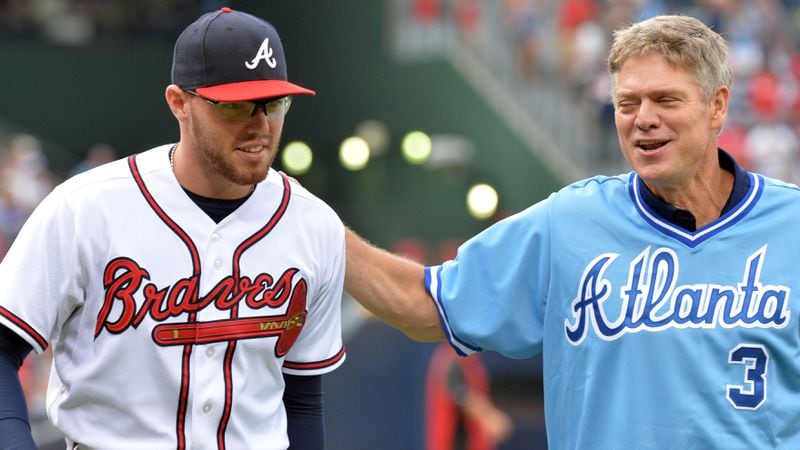 Dale Murphy and Atlanta Braves first baseman Freddie Freeman (left) walks back to dugout after Murphy's celebratory pitch during Dale Murphy Night at Turner Field in 2013.