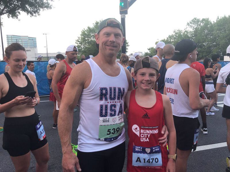 Brandon Young and son, Max, at Atlanta Journal-Constitution Peachtree Road Race on Monday, July 4, 2022.