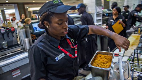September 2, 2015 Atlanta - Kanitra Williams (left) uses a tethered knife at Fresh to Order inside the Hartsfield Jackson Atlanta International Airport on Wednesday, September 2, 2015. Restaurants inside the airport have challenges including limited space, tethered knives, mandatory knife inventory inspections and electric grills.   JONATHAN PHILLIPS / SPECIAL