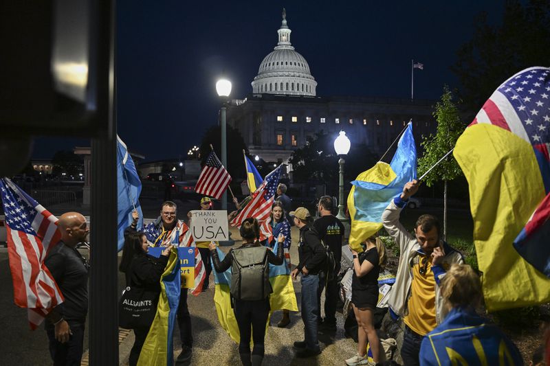 Supporters of Ukraine demonstrated outside the U.S. Capitol in Washington on Tuesday. The Senate passed a $95.3 billion package of aid to Ukraine, Israel and Taiwan. 