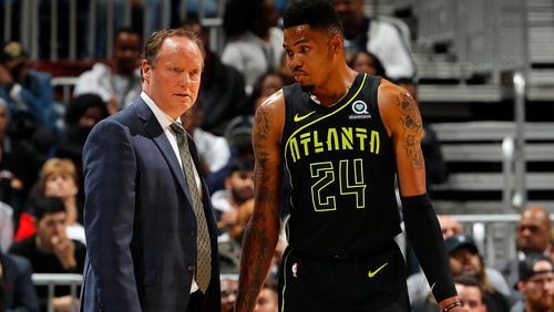 Hawks coach Mike Budenholzer, here with with Kent Bazemore, is fielding potential offers from other teams, including the Phoenix Suns.