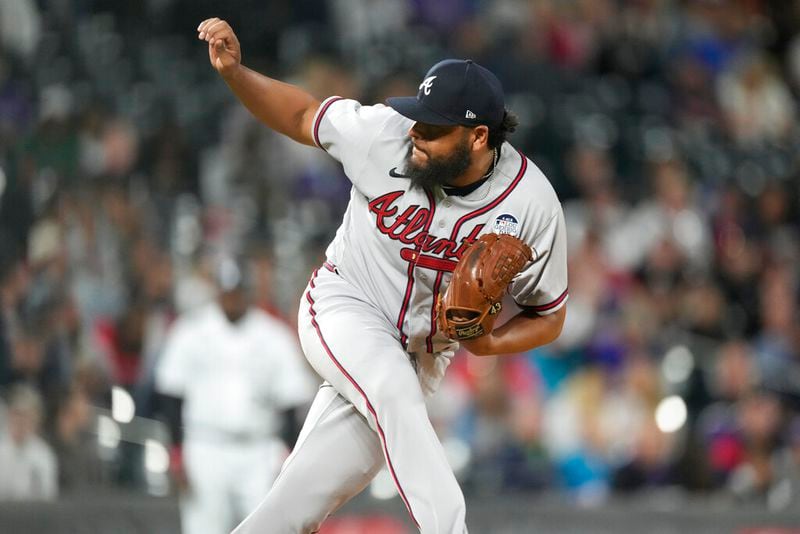 Atlanta Braves relief pitcher Jesus Cruz watches a delivery to a Colorado Rockies batter during the seventh inning of a baseball game Thursday, June 2, 2022, in Denver. (AP Photo/David Zalubowski)