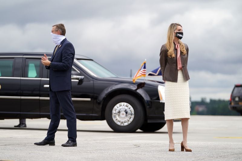 FILE -- Rep. Doug Collins (R-Ga.) and Sen. Kelly Loeffler (R-Ga.) wait to greet President Donald Trump at the airport in Atlanta on Sept. 25, 2020. Collins is running in a special election against Loeffler, who was appointed to her seat; but the Democrat in that race, Raphael Warnock, is now leading in a poll. (Anna Moneymaker/The New York Times)