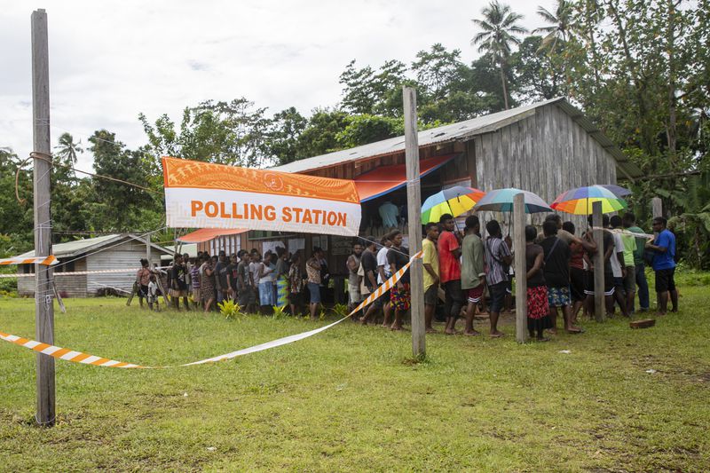 Villagers queue to vote during the Solomon Islands elections in a village on the island of San Cristobal, Wednesday, April 17, 2024. Voting has closed across Solomon Islands on Wednesday in the South Pacific nation's first general election since the government switched diplomatic allegiances from Taiwan to Beijing and struck a secret security pact that has raised fears of the Chinese navy gaining a foothold in the region.(AP Photo/Charley Piringi)