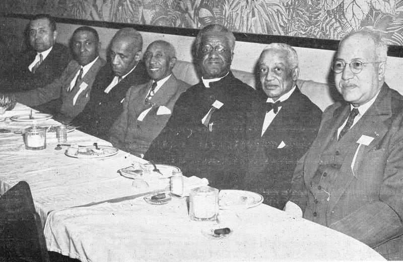 Sigma Royalty. In this 1949 photo, two of the fraternity's founders A. Langston Taylor (second from left) and Leonard F. Morse (wearing the religious collar), attend a dinner with the brothers. Scholar Alain Leroy Locke is second from right.