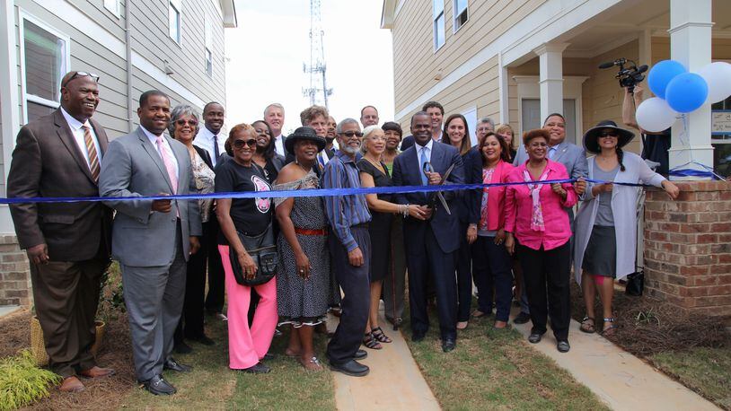 Atlanta Mayor Kasim Reed joins city and community officials Wednesday during a ribbon cutting ceremony celebrating new affordable housing for residents in Mechanicsville.