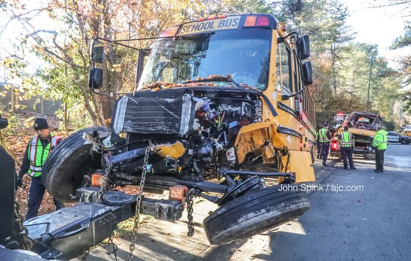 Crews work to haul away a wrecked Marietta City Schools bus involved in a head-on crash on Manning Road on Thursday morning.