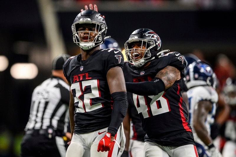 Falcons safety Jaylinn Hawkins (32) and inside linebacker Dorian Etheridge (48) celebrate a sack during the first half against the Tennessee Titans, Friday, Aug. 13, 2021, in Atlanta. (Danny Karnik/AP)