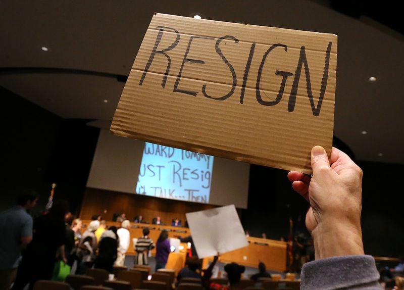 Rachel Theus holds a “resign” sign during a Feb. 28, 2017, meeting where protesters demanded the resignation of Tommy Hunter, the Gwinnett County commissioner that called U.S. Rep. John Lewis a “racist pig” on Facebook. CURTIS COMPTON/CCOMPTON@AJC.COM