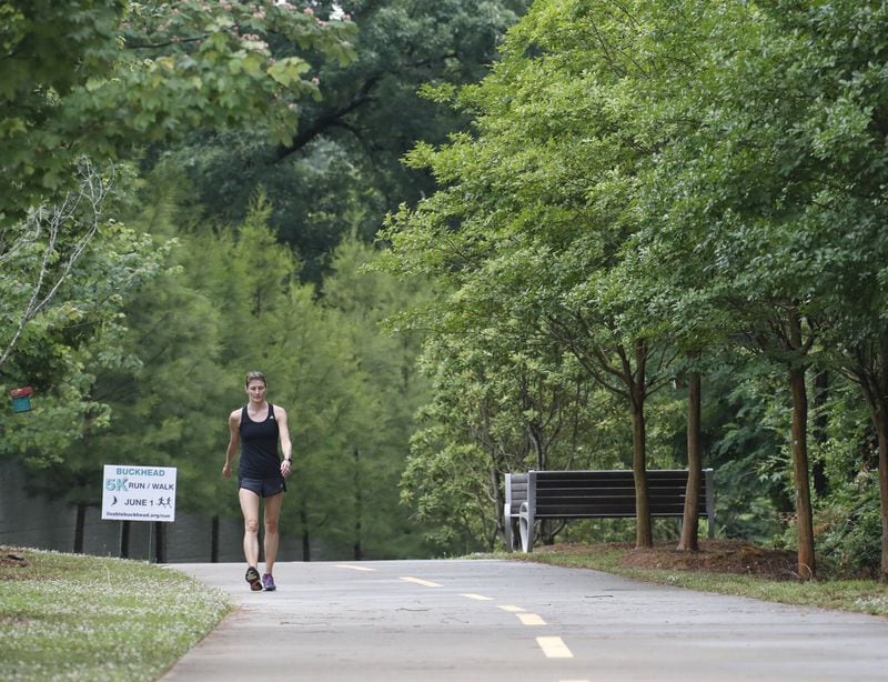 Sondra Cheney of Buckhead walks along a northern section of PATH400, which runs along Ga. 400. A new segment will open this fall, linking this stretch to another in south Buckhead. BOB ANDRES / BANDRES@AJC.COM