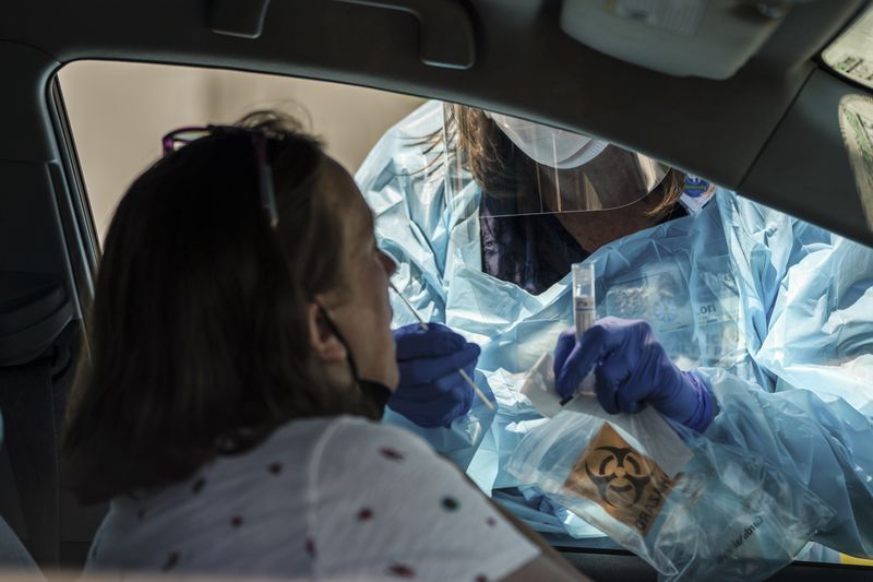 In this file photo, A Jackson County Health Department nurse administers a COVID-19 test in Independence, Mo. on July 13. (Christopher Smith/The New York Times)