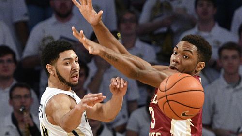 Georgia Tech guard Josh Heath, left, passes as Florida State guard Trent Forrest (3) defends during the first half of an NCAA basketball game, Wednesday, Jan. 25, 2017, in Atlanta. (AP Photo/John Amis)