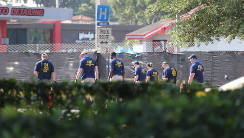 FBI investigators process the scene near Pulse nightclub in Orlando. AJC photos: Curtis Compton