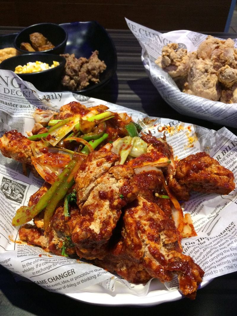 A half-and-half order of Thank U Chicken’s Spicy Fried Chicken, the traditional style (upper right) and sides. CONTRIBUTED BY WENDELL BROCK