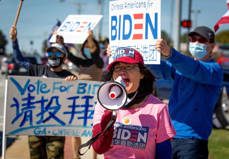 
Asian Americans Democratic Club chairwoman Bilan Liao leads a group in chants during a "Chinese for Biden" sign-waving rally along Pleasant Hill Rd. on Saturday, October 17, 2020.   STEVE SCHAEFER / SPECIAL TO THE AJC 