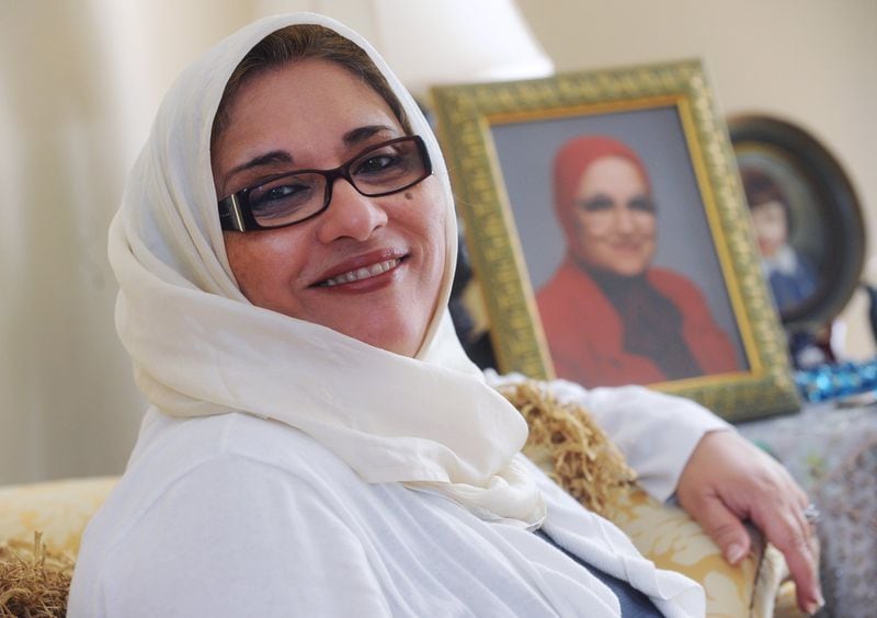 Soumaya Khalifa, founder of the Islamic Speakers’ Bureau. Behind her is a photograph of her mother, Aida Geumei, with whom she performed the hajj pilgrimage to Mecca in 2000. Bita Honarvar bhonarvar@ajc.com