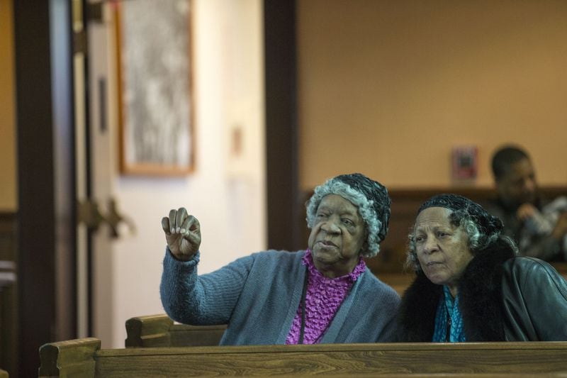 Mildred Lewis, left, and Dyanne Moultrie, both of Boston, take in the view of the historic Ebenezer Baptist Church while visiting at the Martin Luther King Jr. National Historic Park on Wednesday. ALYSSA POINTER/ALYSSA.POINTER@AJC.COM